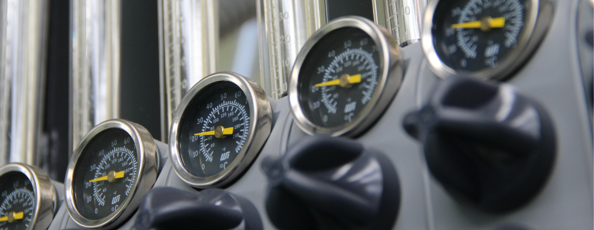 A row of dials attached to pipes, for an article on creative priorities