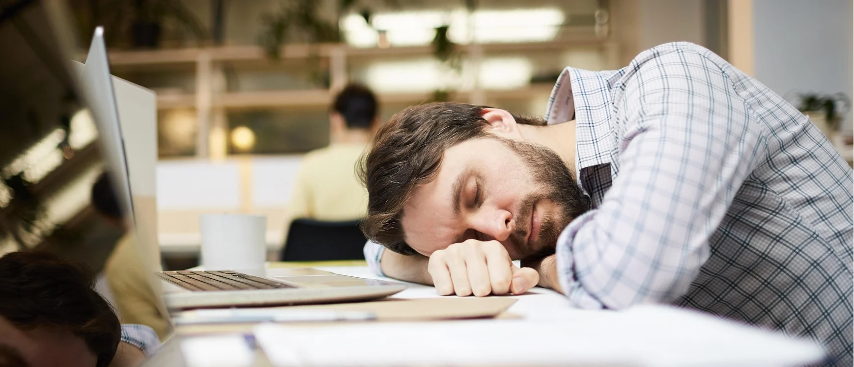 A man sleeping at his desk, to illustrate an article on boring jobs