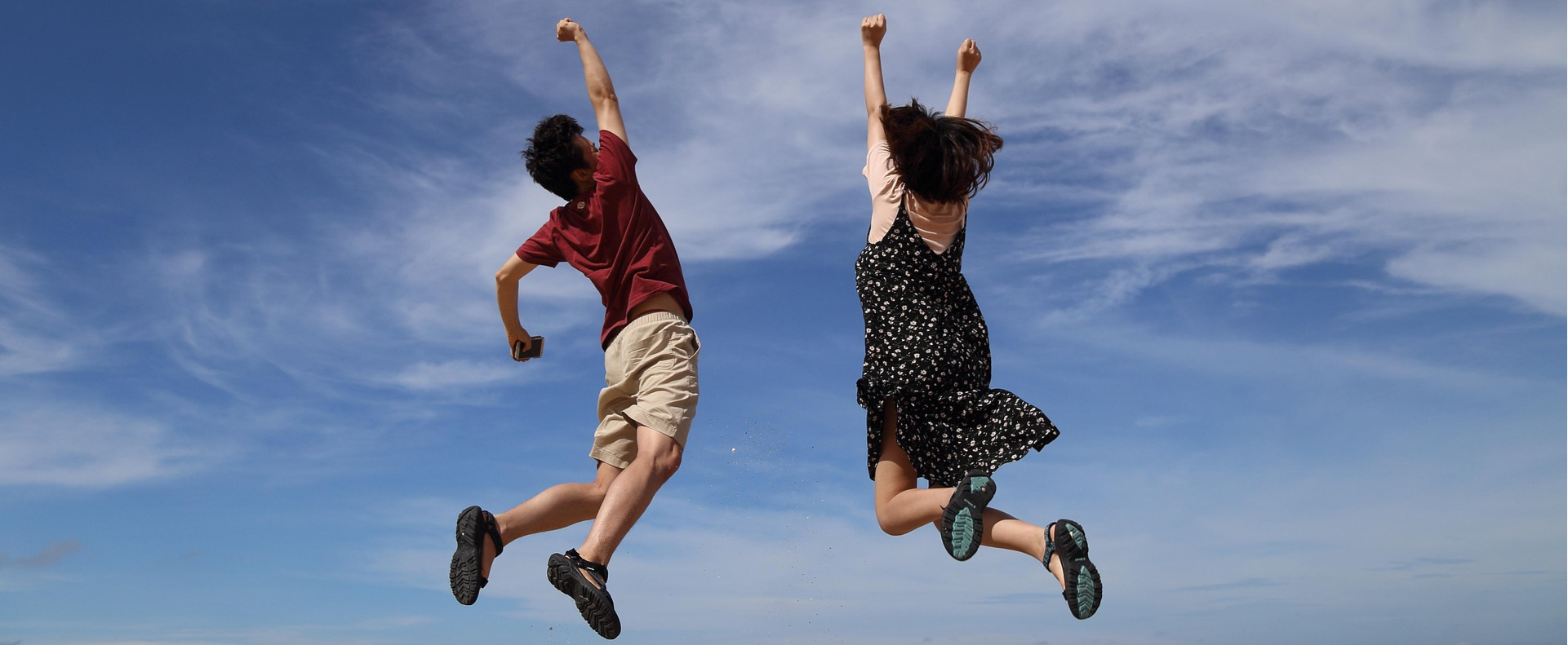 Two people jumping into the air